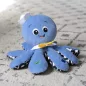 BABY EINSTEIN Zenélő játék polip Octoplush™ 3m+